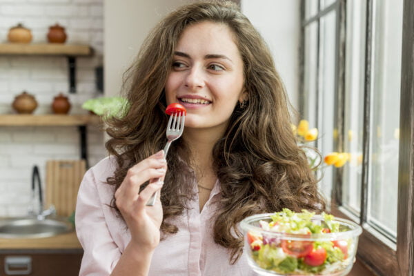 Freepik Imagem Mulher morena comendo uma salada